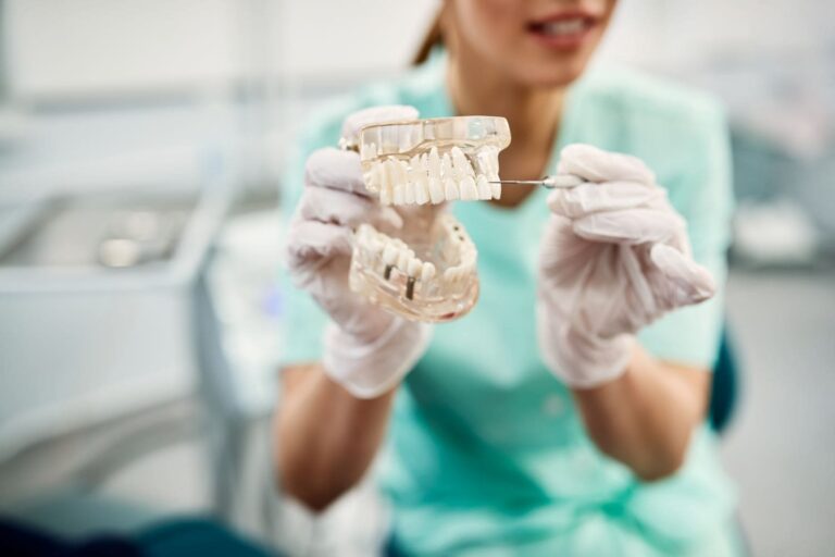 close up of dentist holding dentures and showing h 2022 09 23 22 14 09 utc 1