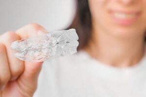 close up of clear aligners in hand of woman ortho 2021 09 30 20 50 02 utc